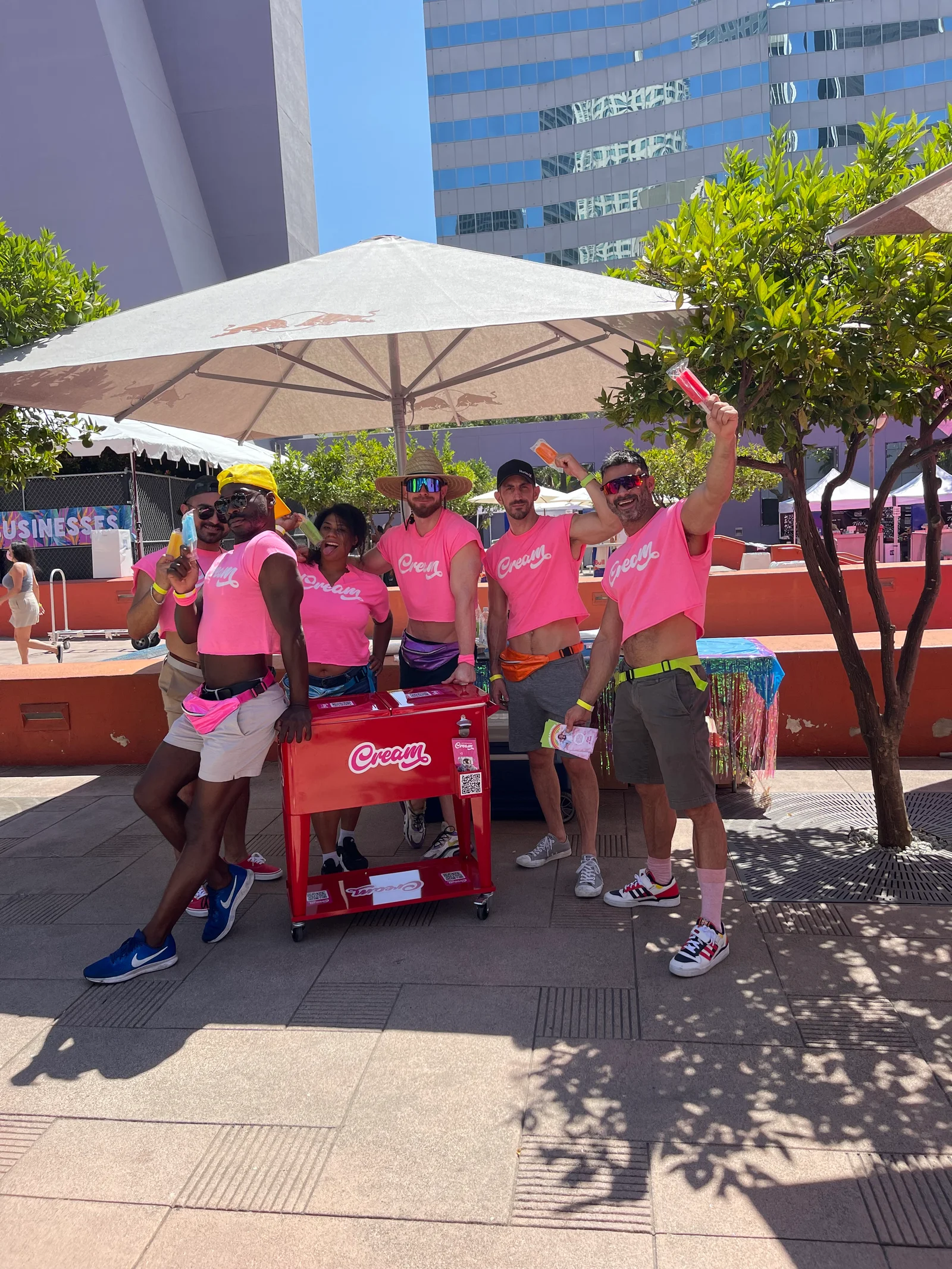 Cream team members with a branded cart and popsicles at an outdoor gathering