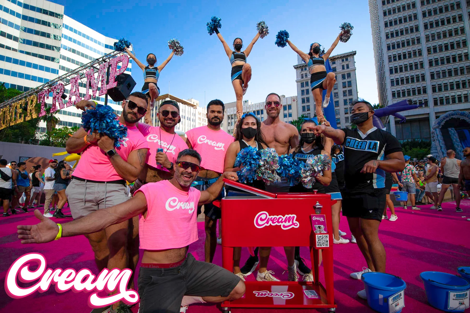 Cream team and community participants with branded shirts and a Cream cart at an outdoor event